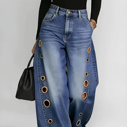Retro-style wide-leg jeans with metallic eyelets, high-waisted, loose, floor-length fit, gradient eyelets of varying sizes on both sides, distressed washed finish, classic front and back pockets, perfect for everyday casual w